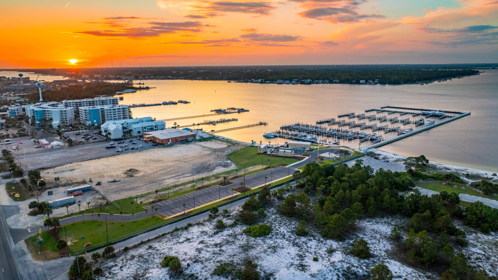 Sunset Isle marina and Yacht Club aerial view from shore at sunset