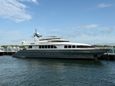 A luxury yacht docked at a marina under a clear blue sky in Fort Walton Beach.