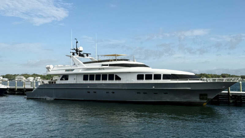 A luxury yacht docked at a marina under a clear blue sky in Fort Walton Beach.