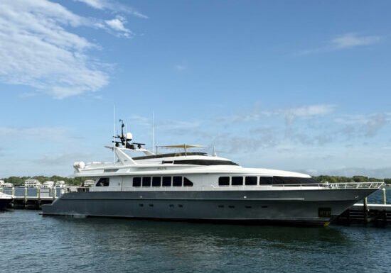 A luxury yacht docked at a marina under a clear blue sky in Fort Walton Beach.